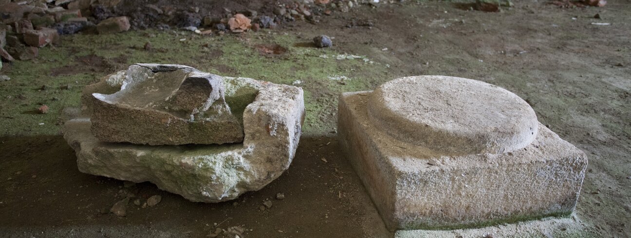 Interiér venkovské synagogy v Polici u Jemnice, stav před obnovou, kamenná patka sloupu v původním umístění a zbytky kamenných prvků (autor: Viktor Mašát)